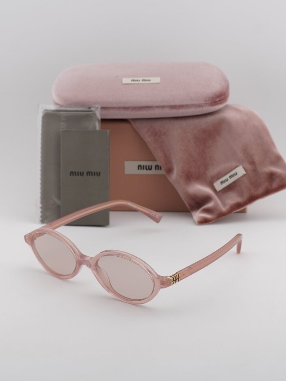 Miu Miu MU04ZS 20I60V Oval Sunglasses – Opaline Pink\Pink